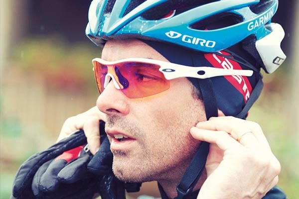 Road cyclist wearing Giro helmet and Oakley sunglasses