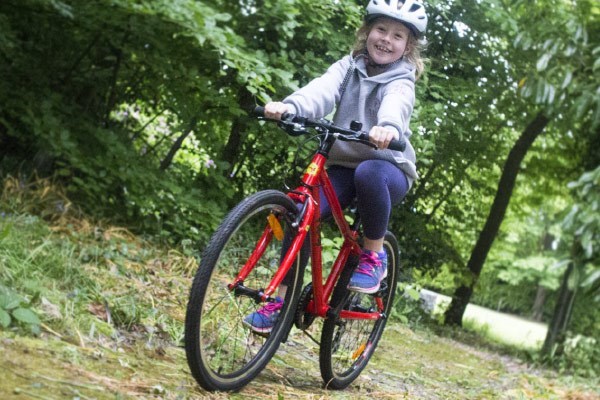 child riding bike in woods