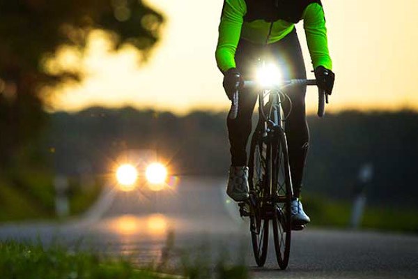 Road cyclist with a bright front light