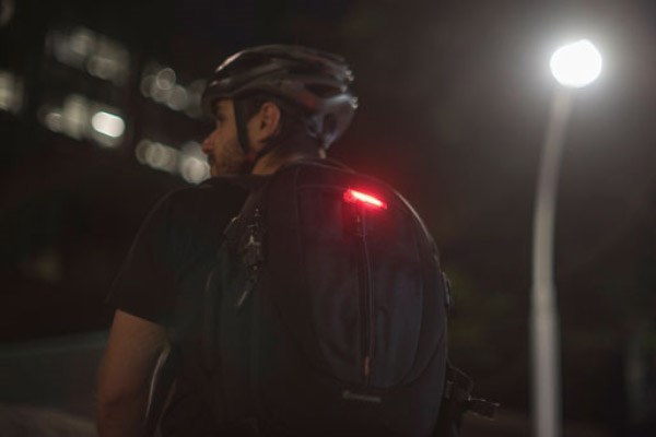 Rear light being worn on a backpack