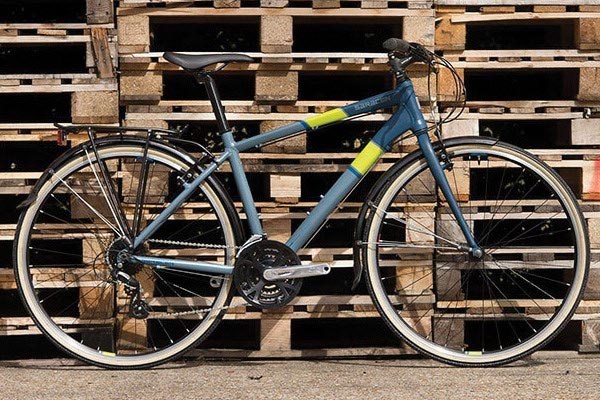 A hybrid bike fitted with full-length mudguards connected to the fork and frame's eyelets