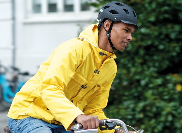 A guy in a bright yellow long sleeve jacket in a helmet
