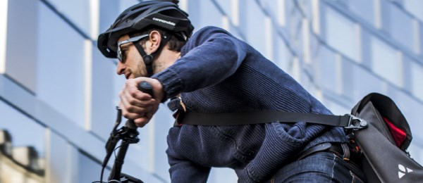 A close up view of a urban commuter on his way to work wearing a helmet