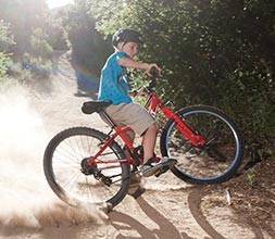 Kid doing a skid on a bike