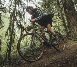 riding a Norco gravel bike in the woods