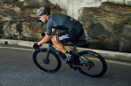A road cyclist taking a corner at speed on the BMC Timemachine