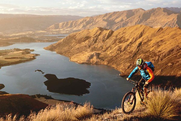 A mountain biker at the top of a scenic climb