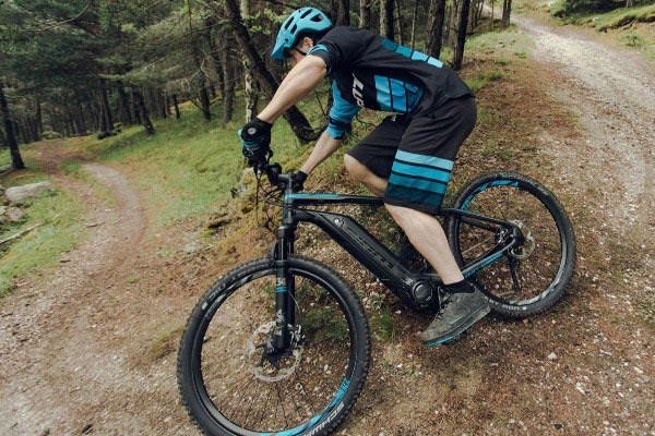 Close up of a mountain biker riding an electric mountain bike motor