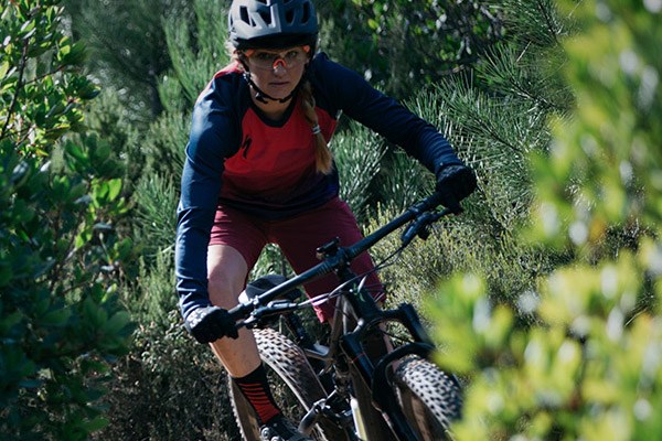 A mountain biker wearing a long sleeve jersey