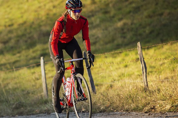 Road cyclist wearing a race/athletic-fit jersey