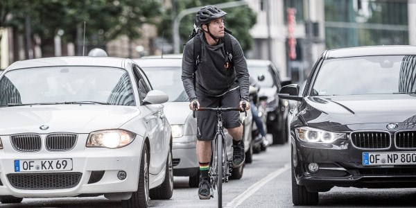 Cyclist riding amongst traffic