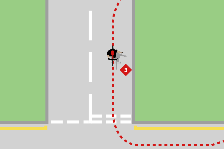 A cyclist turning left onto a main road