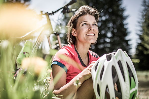 Female cyclist with a Merida mountain bike and helmet