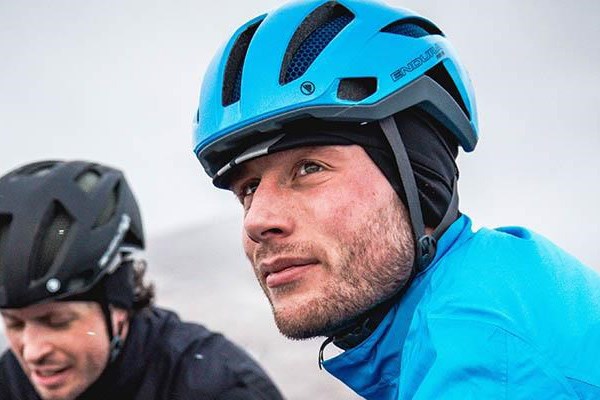 Cyclist wearing endura winter cycling cap under helmet