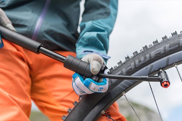 pumping up a bike tyre with a hand pump