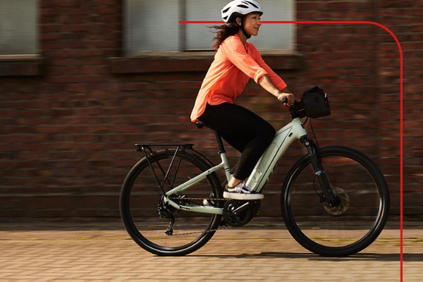 A commuter rides to work on an Electric Liv Hybrid Bike