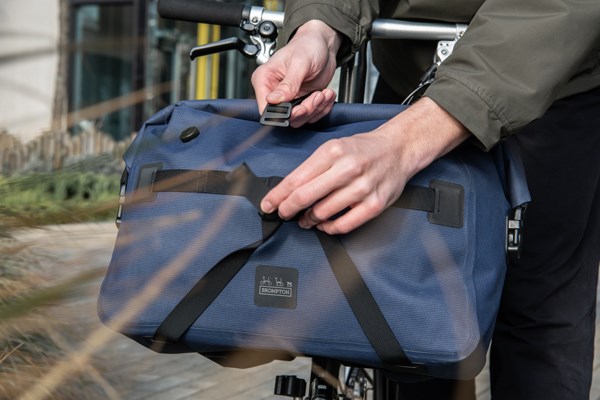 Brompton have a variety of luggage options. Either mounted to the headtube or to a rear luggage rack.