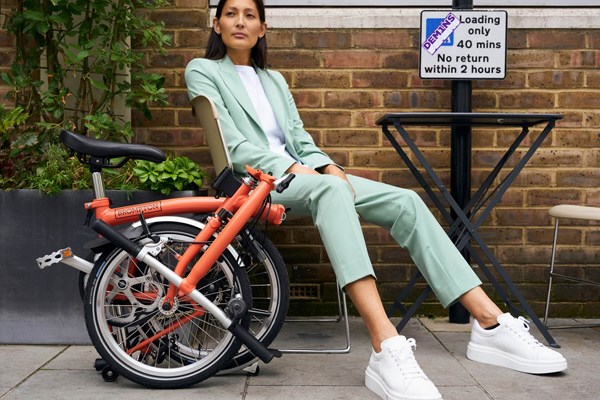 Woman sitting with a Brompton folded
