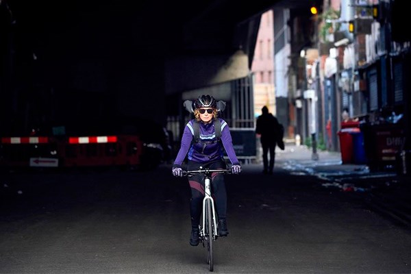 Female cycling through city