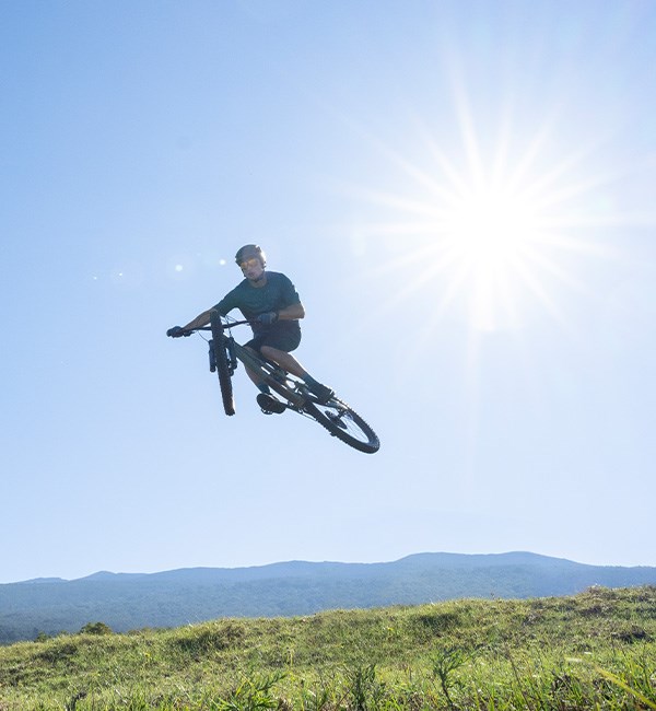 mountain biker jumping in the sun