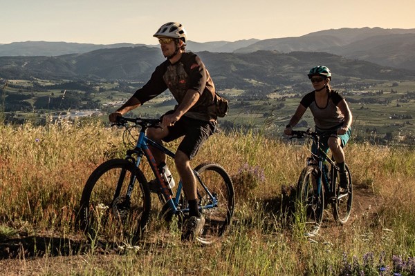 couple riding hardtail mountain bikes
