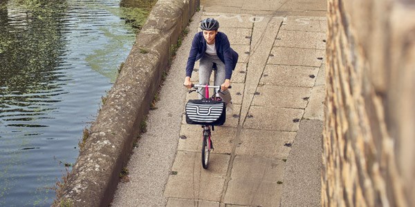 A commuter riding along a canal pathway