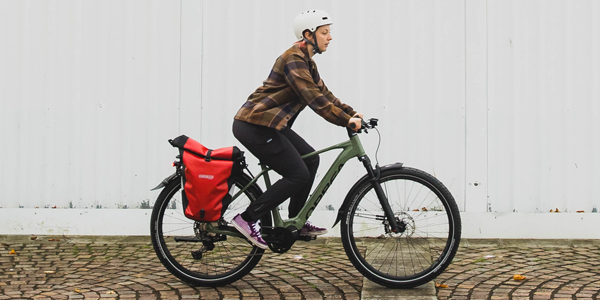 A cycle commuter uses Altura waterproof panniers to keep their work essentials dry