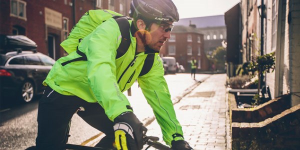 A road cyclist wearing a lightweight packable waterproof jacket