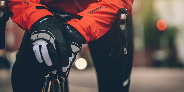 A road cyclist wearing long finger gloves