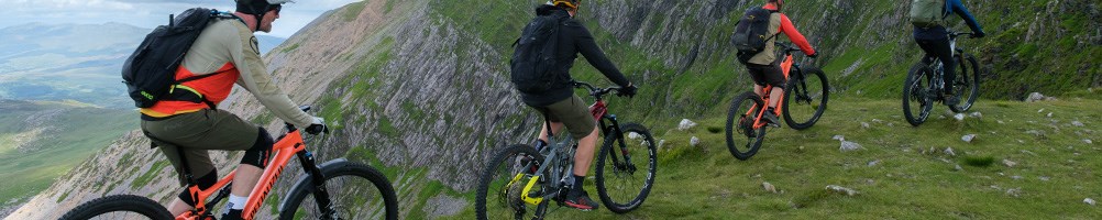 4 e-bikers riding in the welsh mountains