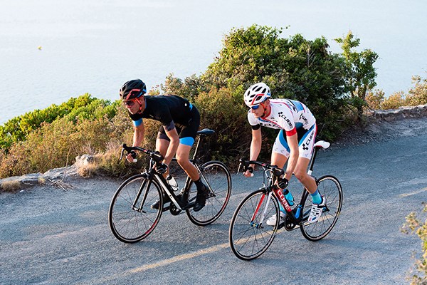 Two cyclists riding cube road bikes