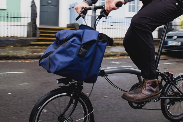 A Brompton with a bag mounted to the steerer tube