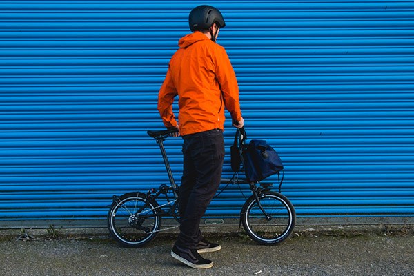 A cycle commuter wearing a waterproof jacket and trousers